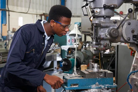 46133904-male-apprentice-engineer-working-on-drill-in-factory
